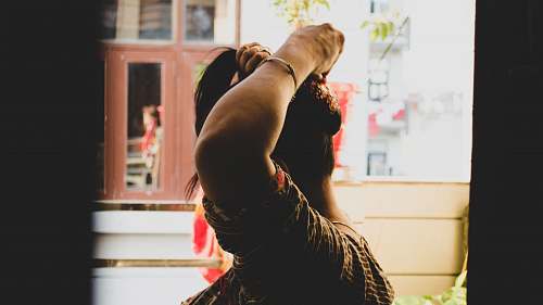 dance pose woman tying hair leisure activities